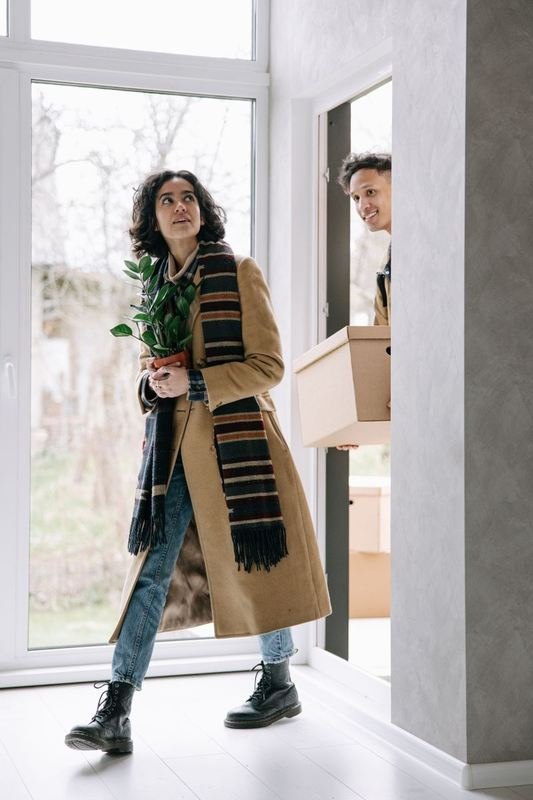 All The Right Moves mover carrying a sofa through a doorway